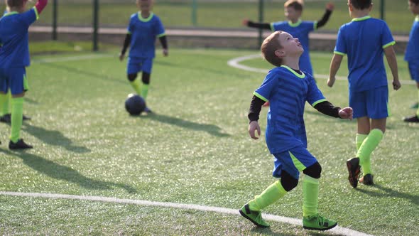 Active Footballer Kicking Ball During Training