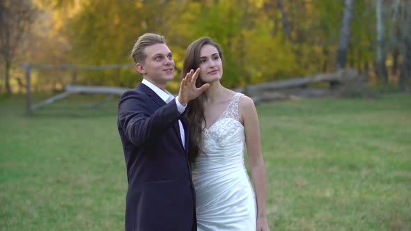 Young Man Makes a Surprise To His Bride. Beautiful Brunette with Surprised Wow Face Expression Very