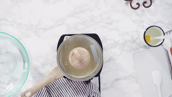 Time lapse. Flat lay. Step by step. Caramelizing sugar in a small cooking pot 