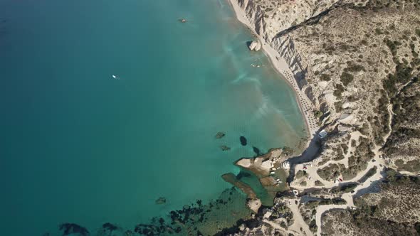 Vibrantly turquoise waters roll onto luxurious holiday beach in Greece. Summertime Milos Greece 4k.