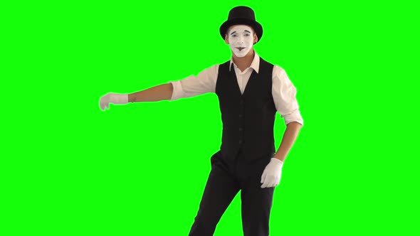 Funny Male Mime in White and Black Clothes Imitating Relaxation