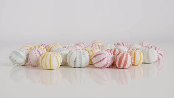 Grouped colorful  striped sugar bonbons slow tilt 4K video