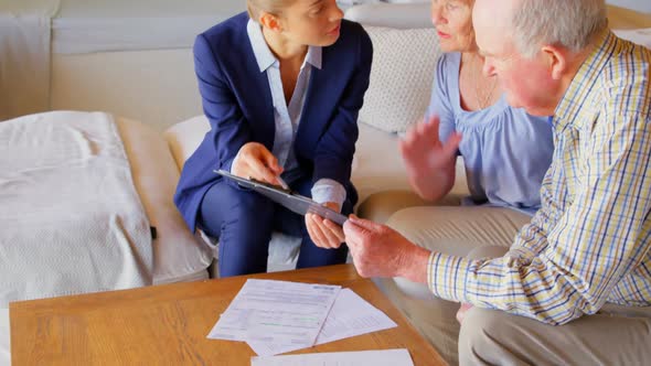 Side view of senior Caucasian couple meeting with real estate agent in a comfortable home 4k