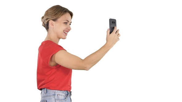 Beautiful Young Woman Walking and Holding a Smartphone