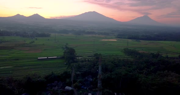 Flight over the countryside in Indonesia with the view of Mount Telemoyo, Andong, Merbabu and Merapi