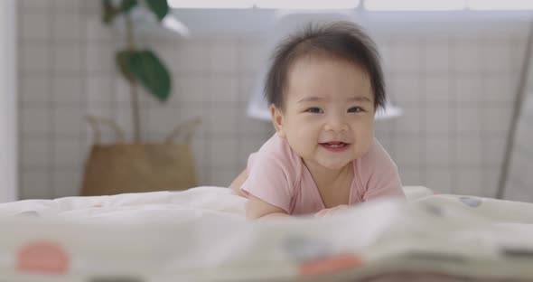 Slow Motion Happy Asian Baby Crawls In The Living Room. Infant Baby Plays with Family.