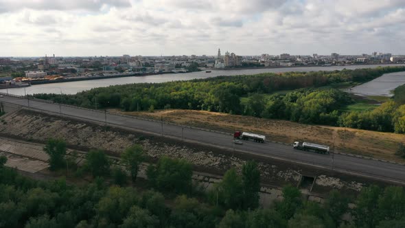 Big cars are driving along the road. Water tanks. Top view.  High quality 4k footage.