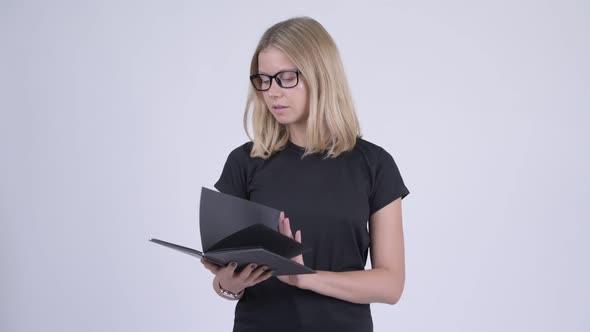 Young Happy Blonde Nerd Woman Reading Book