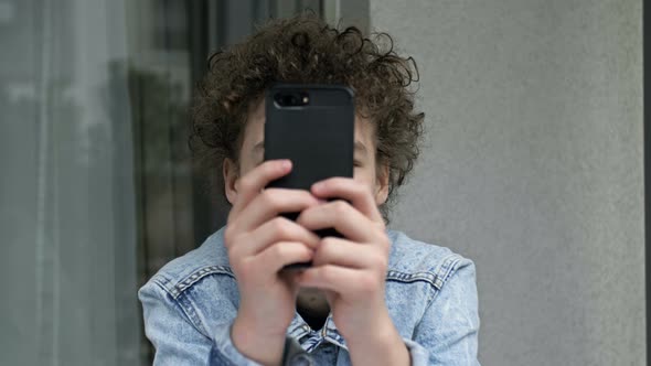 Teenager Who Spends Most of His Time with a Mobile Phone