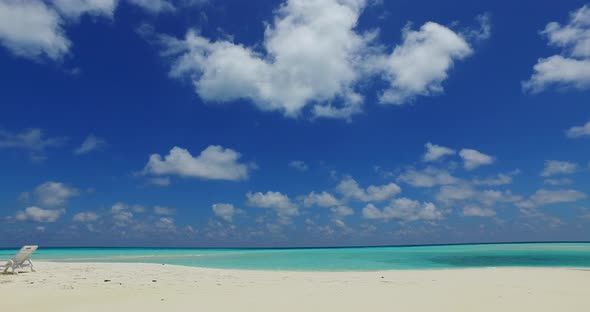 Tropical overhead island view of a sunshine white sandy paradise beach and aqua turquoise water back