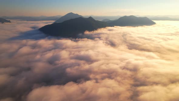 4K Drone Flying through the clouds at dusk or dawn. Aerial top cloudscape