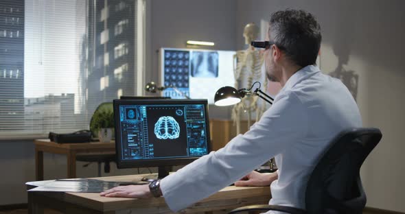 Doctor Analyzing Brain Scan with VR Technology