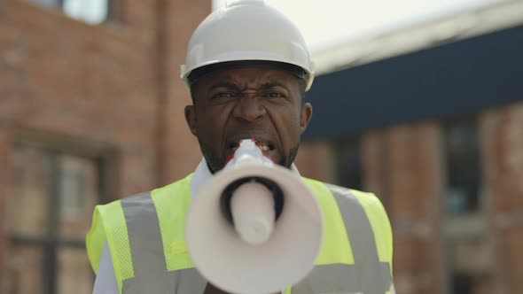 Angry Architect Shouting Into Megaphone Outdoors