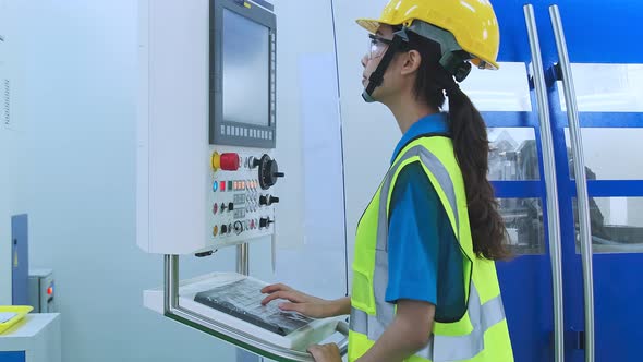 dolly shot of young female technicians work manage  inspecting with control screen