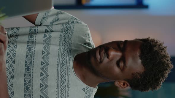 Vertical Video Close Up of African American Man Working on Laptop