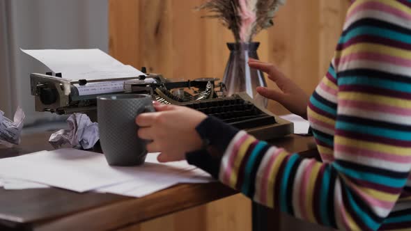 Female Hands Working with Vintage Typewriter