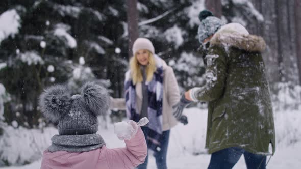 Handheld video of family having snowball fight. Shot with RED helium camera in 8K.