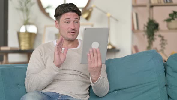 Video Call on Tablet By Male Designer, at Home