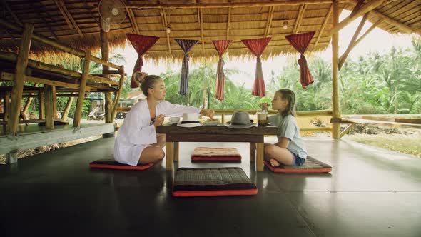 The Happy Family Eat and Drink Tasty Beverages Spending Time in Local Floating Cafe on Water