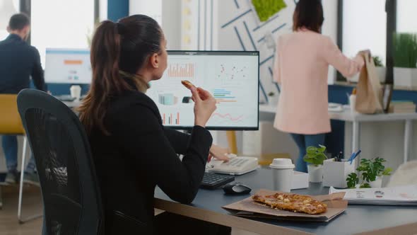 Multitasking Businesswoman Discussing Marketing Strategy with Remote Worker Using Landline