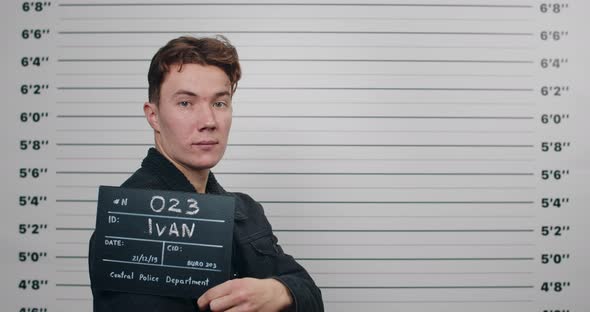 Side Profile Mugshot of Millennial Man with Red Hair Turning Head and Looking to Camera