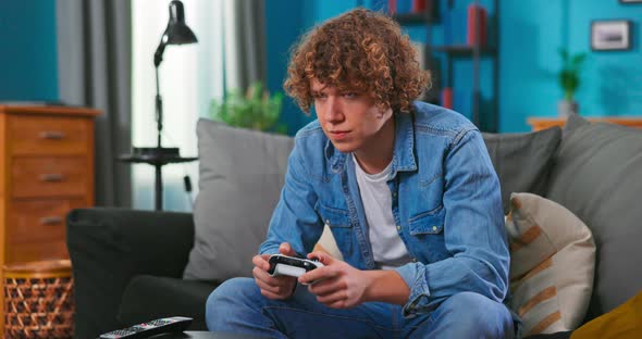 Happy Man Playing Video Games in Apartment  Hilarious Teenager Boy Having Fun with New