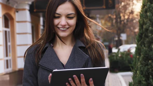 Close-up Portrait of Attractive Young Business Woman Use Tablet Computer and Smile Outdoor, Girl