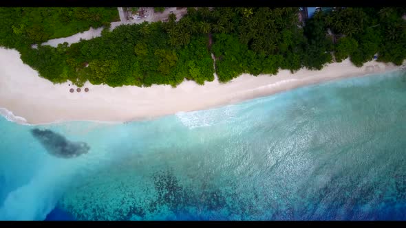 Aerial top down nature of idyllic island beach trip by transparent ocean and white sand background o