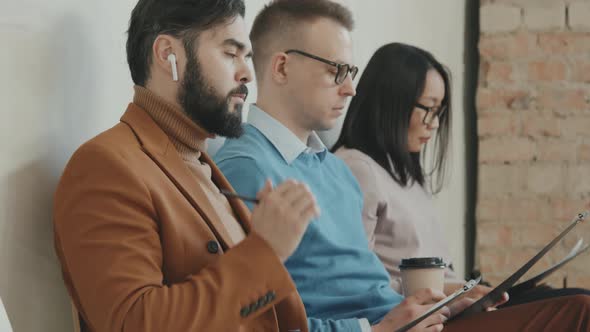 Three People Waiting for Job Interview