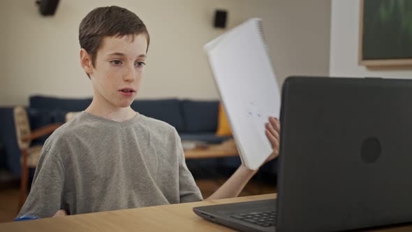 Young boy attending an online lesson during the COVID-19 lockdown