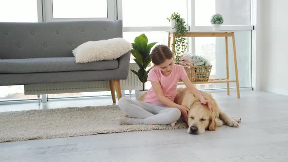 Girl Petting Golden Retriever Dog