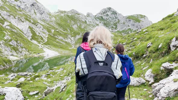 Back View of Family During a Mountain Trip Along Italian Alps Summer Season