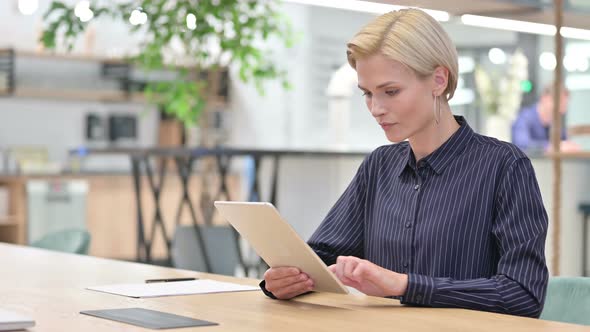 Businesswoman Working on Digital Tablet in Office 