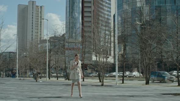 Businesswoman Walking with Smartphone