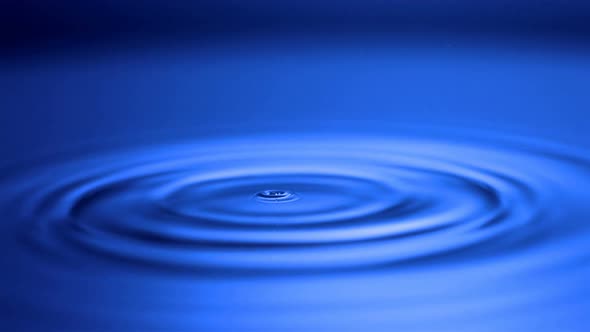 Slow-motion drop hitting water shooting with high speed camera, phantom gold.