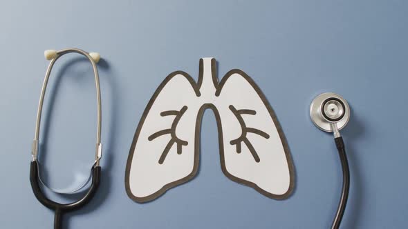 Video of close up of stethoscope with lungs on blue background