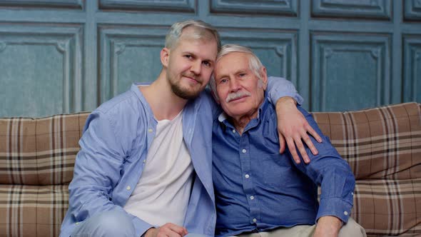 Joyful Excited Young Man Embracing Grayhaired Old Dad or Grandfather Male Generations Family
