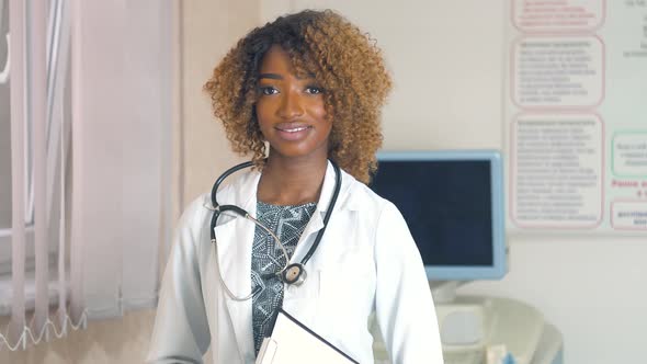 Portrait of Professional African American Female Doctor with Stethoscope in Hospital with Ultrasound