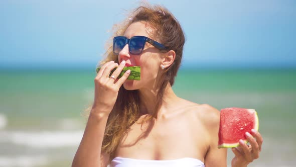 Smiling Woman Eating Watermelon on Beach