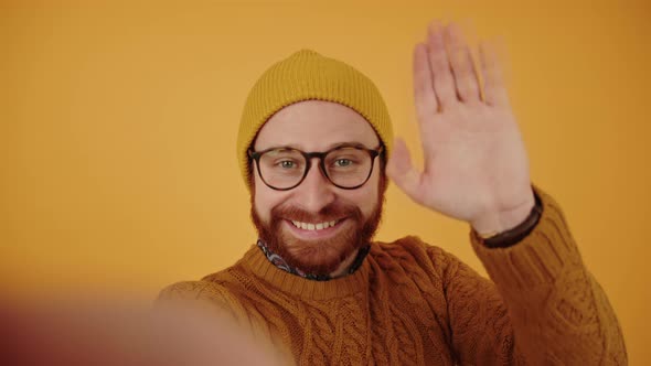 Caucasian Middleaged Millennial Vlogger Man in a Beanie Holding Camera Waving and Promoting