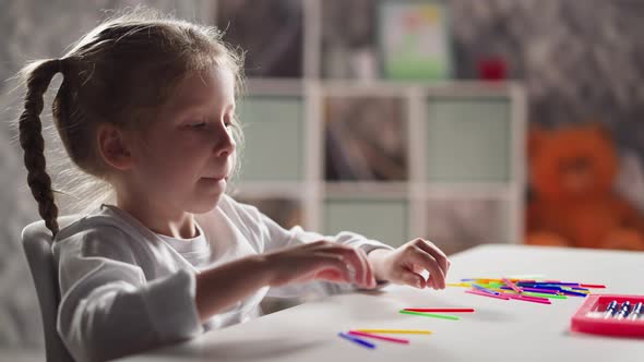 Girl Stretches Arms and Puts Tongue Out Preparing for Lesson