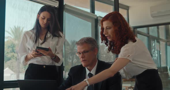 A group of colleagues talking about a new project, sharing ideas during a business meeting.