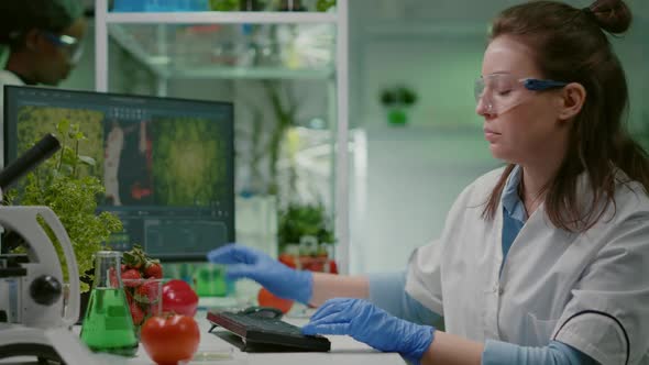 Pharmaceutical Chemist Examining Tomato for Microbiology Experiment