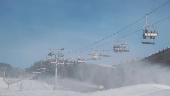 People Take Ski Lift to Skiing on Mountain Slope Sunny Winter Morning