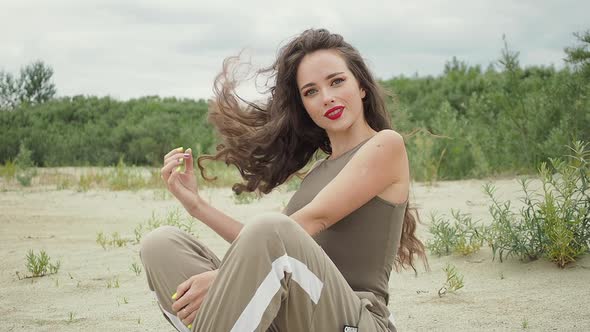 Pretty Woman Touching Hair on Beach