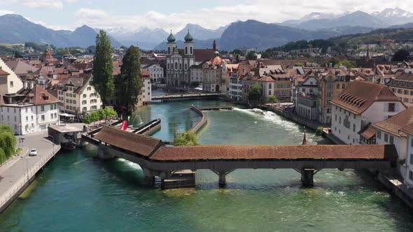 Flying over historic bridge over canal in Luzern Switzerland