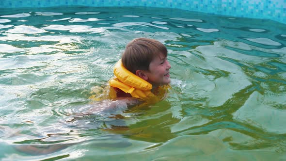 A Little Boy Swimming in the Inflatable Pool