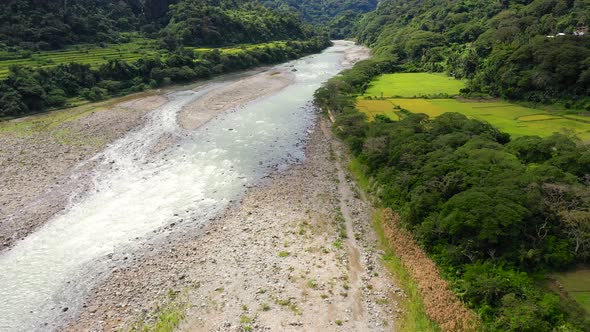 River in Mountain Valley with Bright Meadow