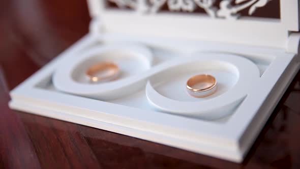 Two Rings in a White, Wooden, Decorative Box.