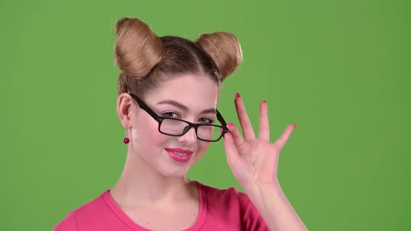 Teenager in Glasses Flirts with a Guy. Green Screen